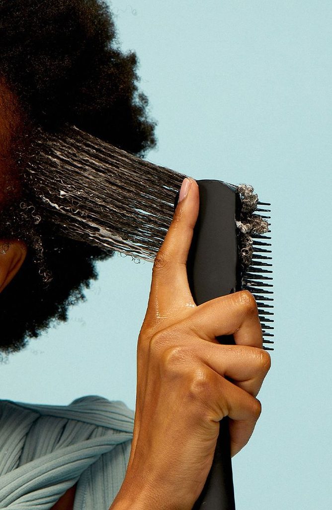 a woman detangling her ends first