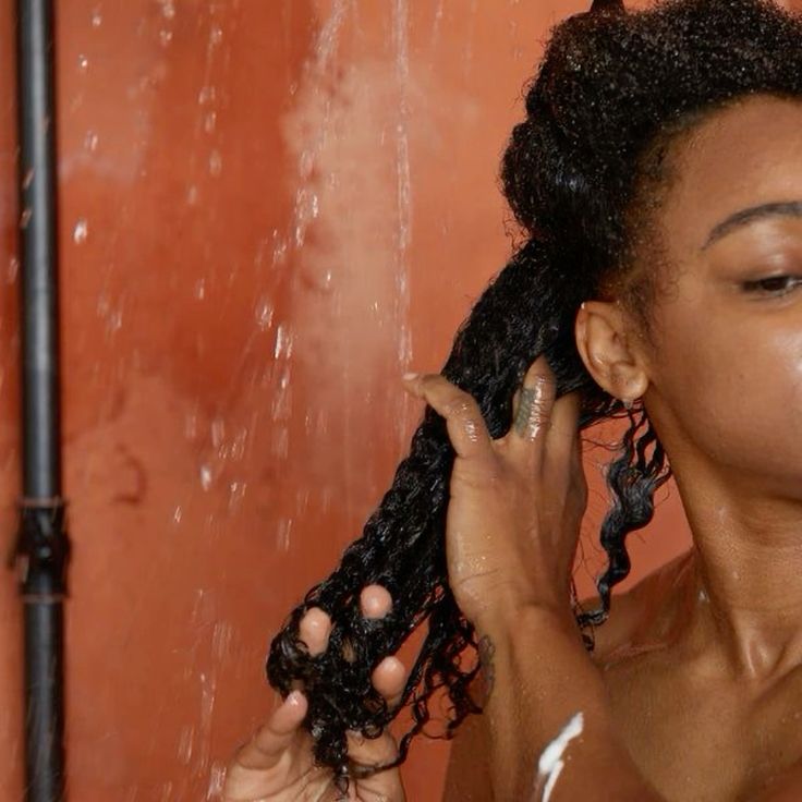 woman finger detangling her hair