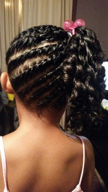 Black child wearing flat twists gathered into a side ponytail protective style