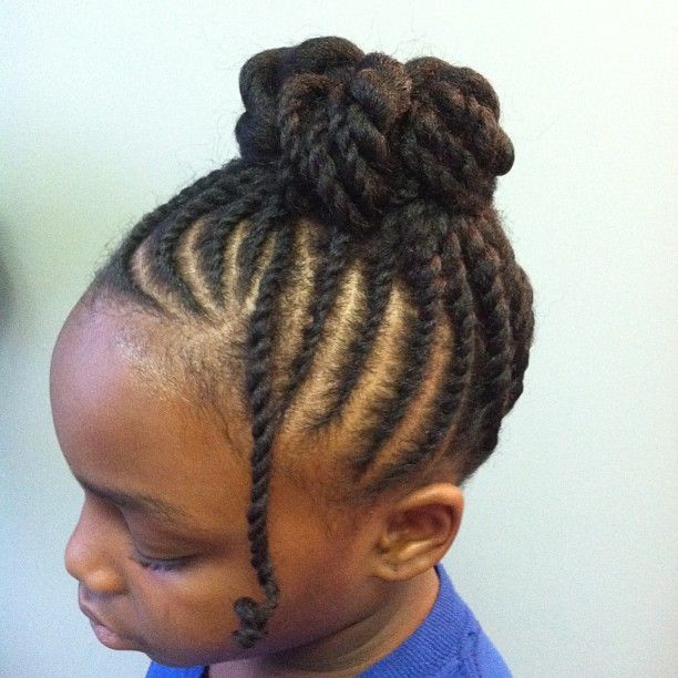 Young Black child wearing large flat twists gathered into a bun