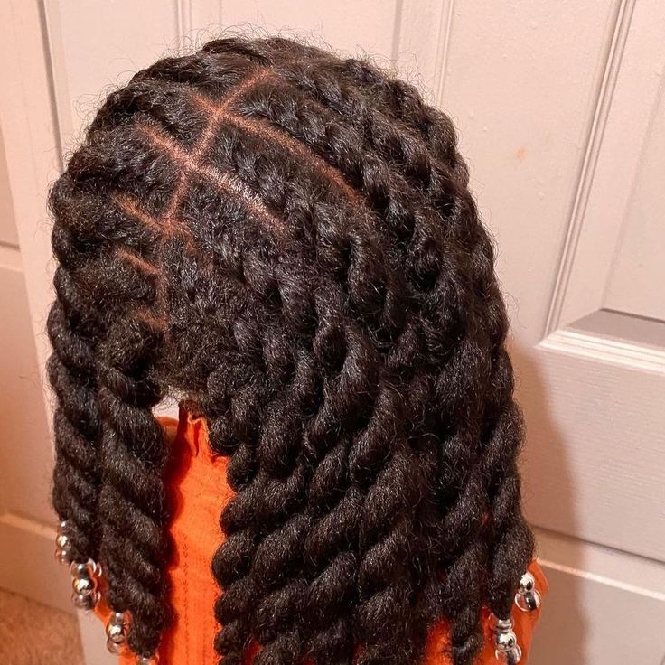 Young Black child wearing simple flat twists protective styles in natural hair