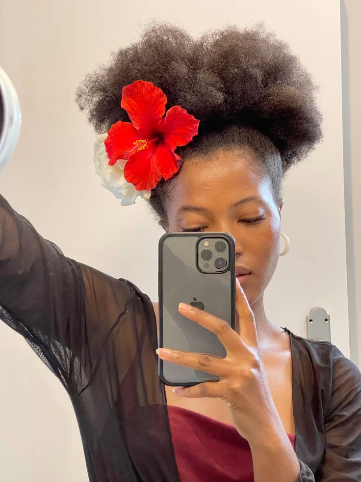 Natural 4C puff hairstyle with a flower hair accessory