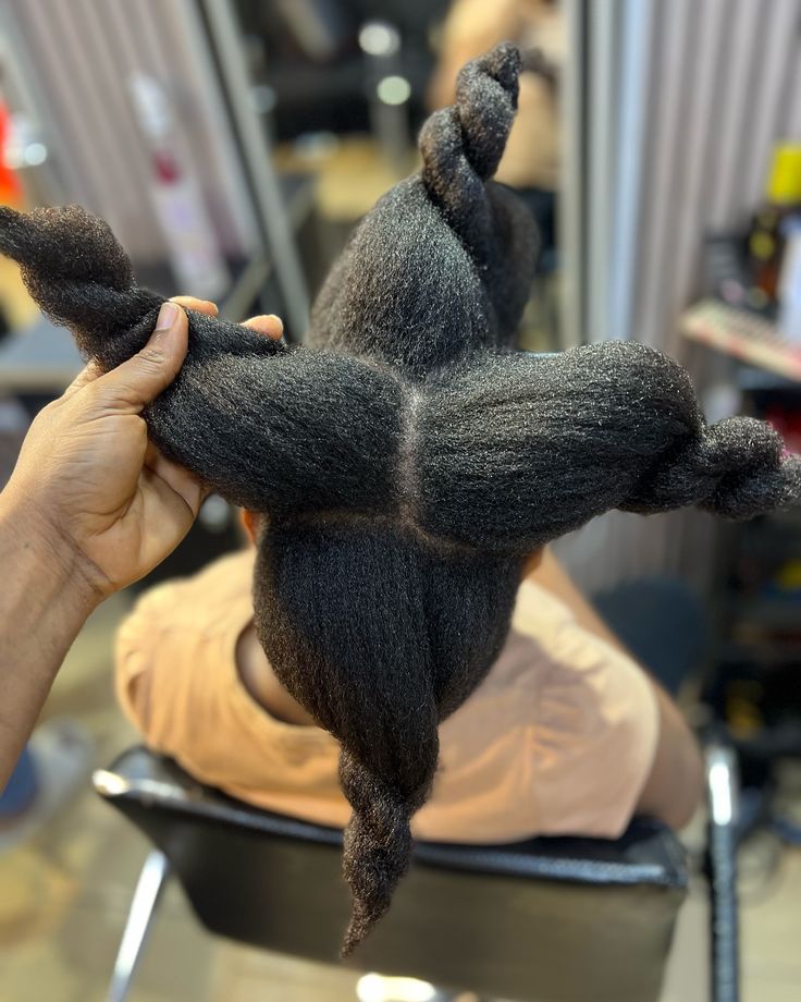 Woman gently handling sectioned natural 4C hair