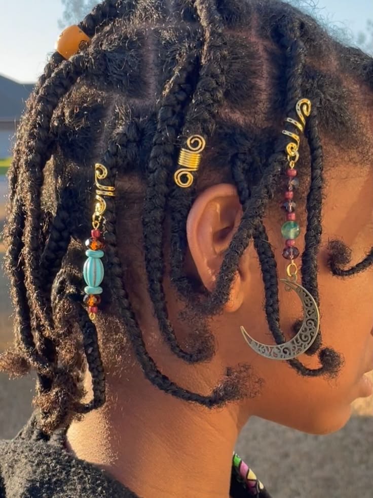 Natural braids decorated with small hair charms