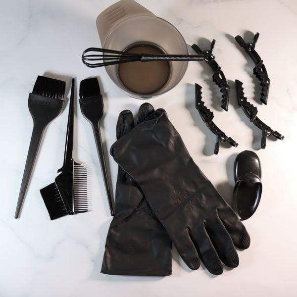 Hair coloring tools and supplies arranged before a home color treatment