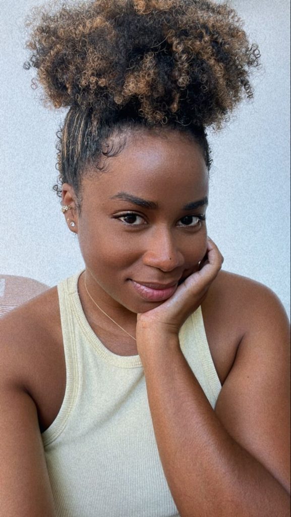 Black woman with warm highlights in natural textured hair