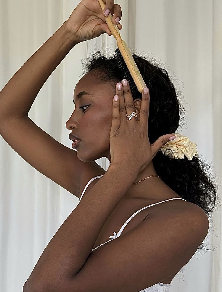 woman gently brushing her hairline