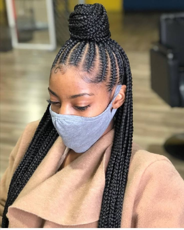 Woman with half-up braided bun and loose braids