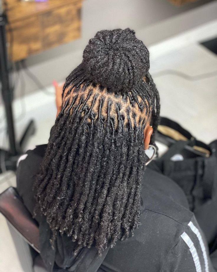 Half-up bun hairstyle on longer starter loc