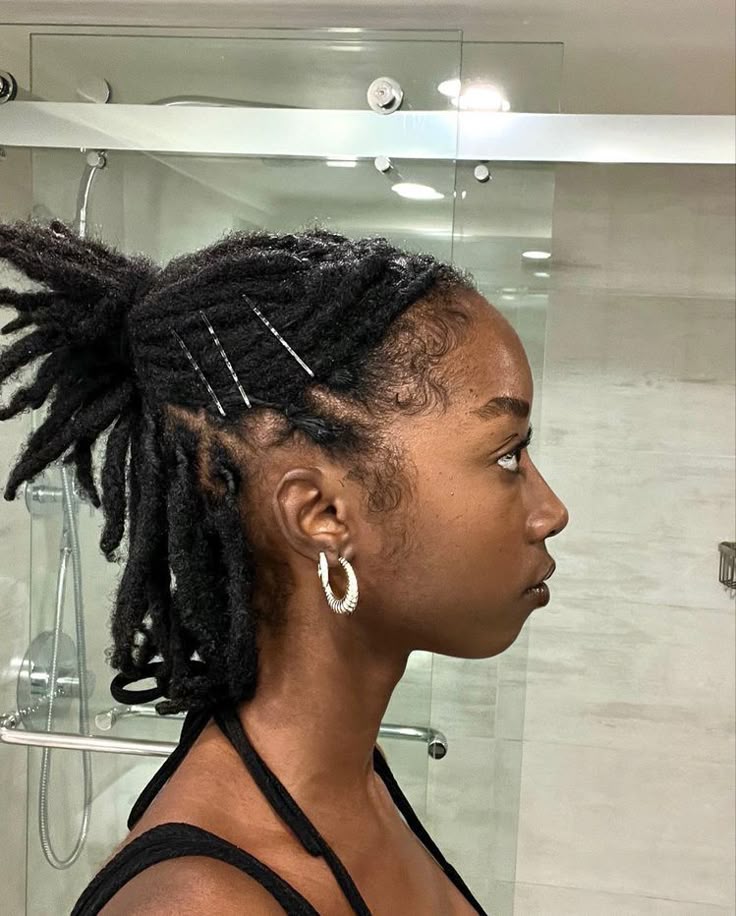 Half-up hairstyle created with short starter locs