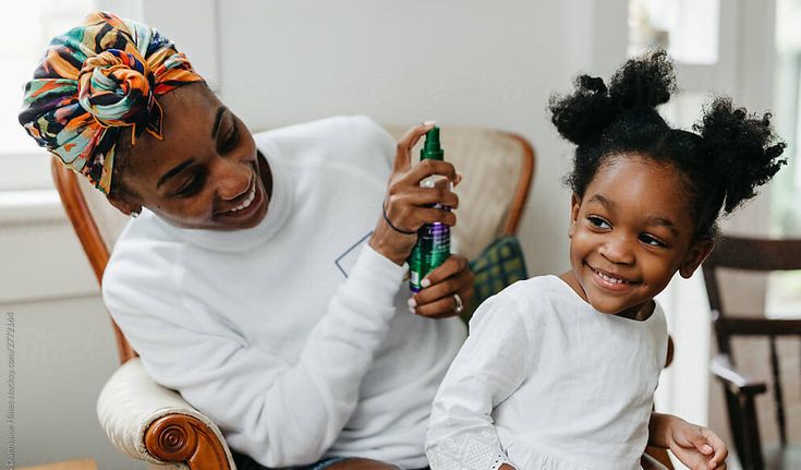 Happy child sitting comfortably during a gentle natural hair care session