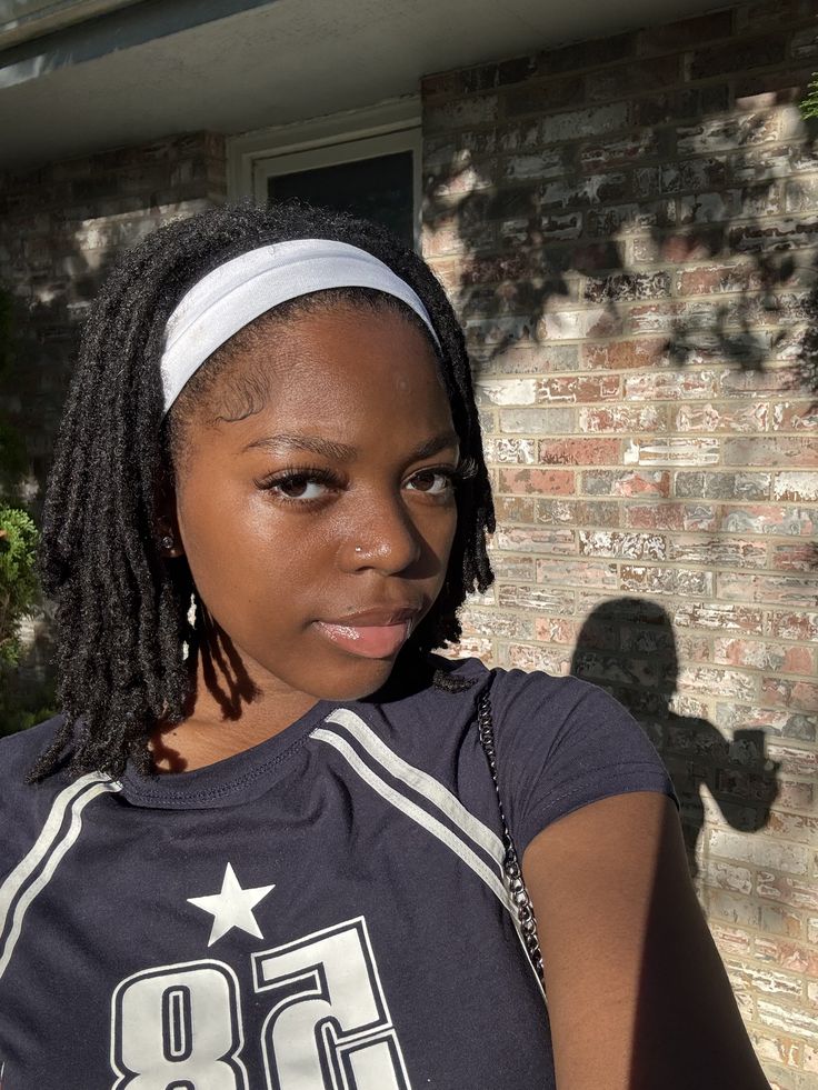 Short starter locs styled with a simple fabric headband