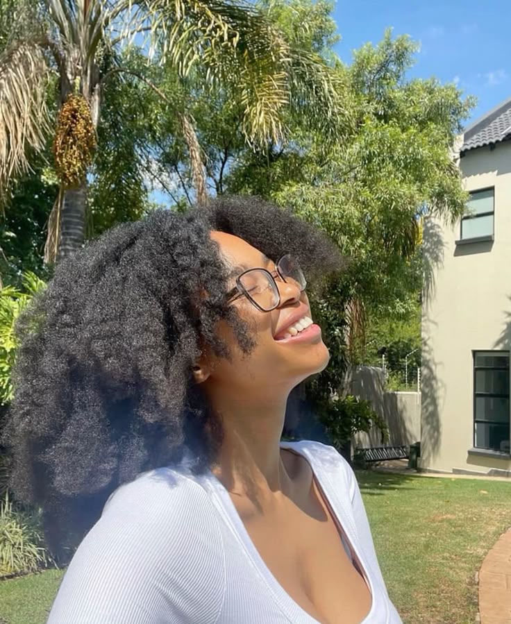 A woman smiling with healthy c hair during summer