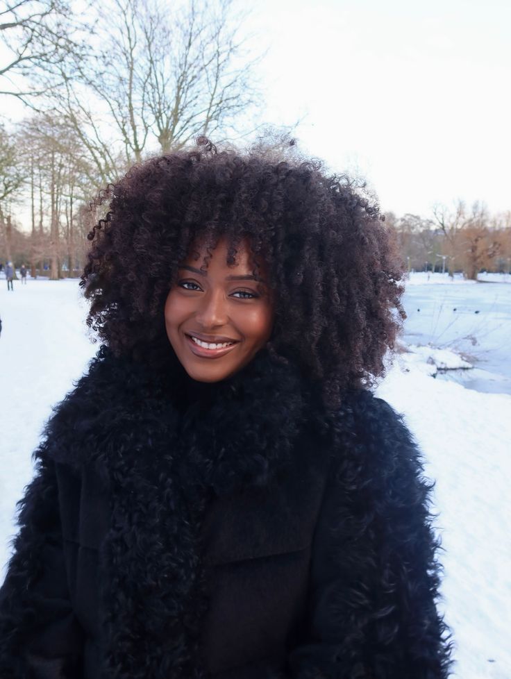 Woman with healthy moisturized natural 4C hair during winter