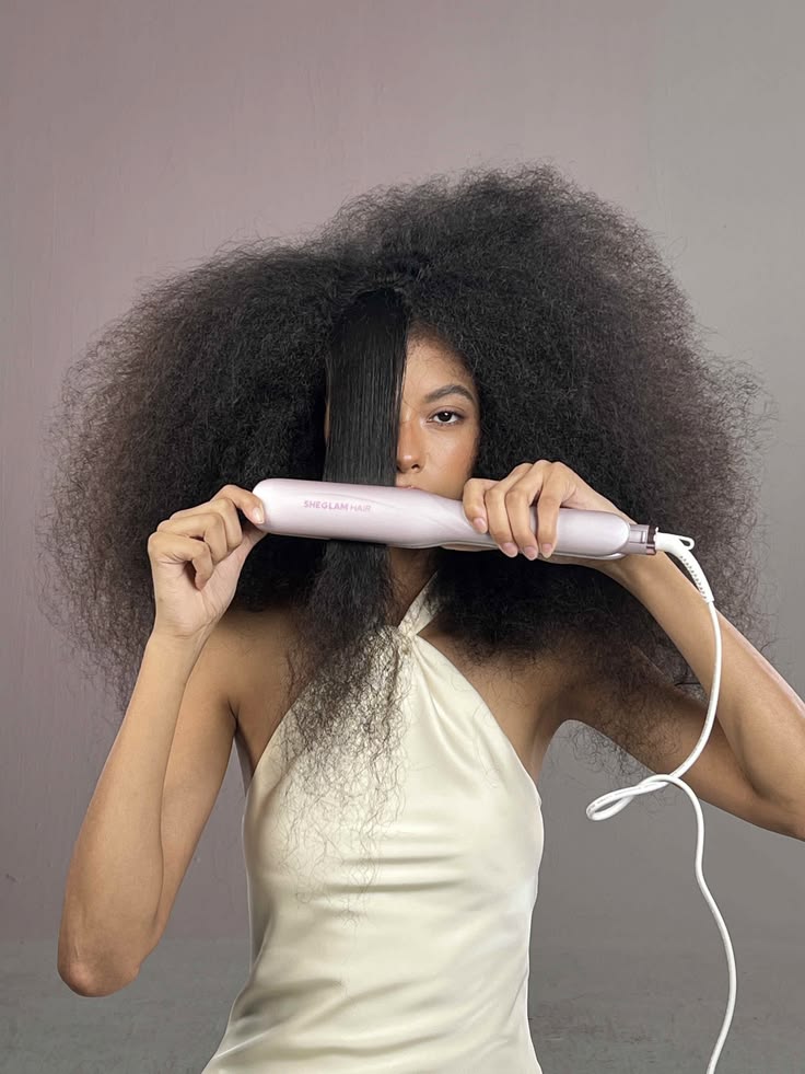 woman stretching her hair with heat
