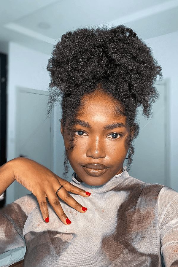 High puff hairstyle with loose tendrils on natural 4C hair