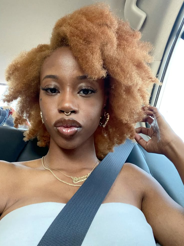 Black woman with warm honey blonde natural hair