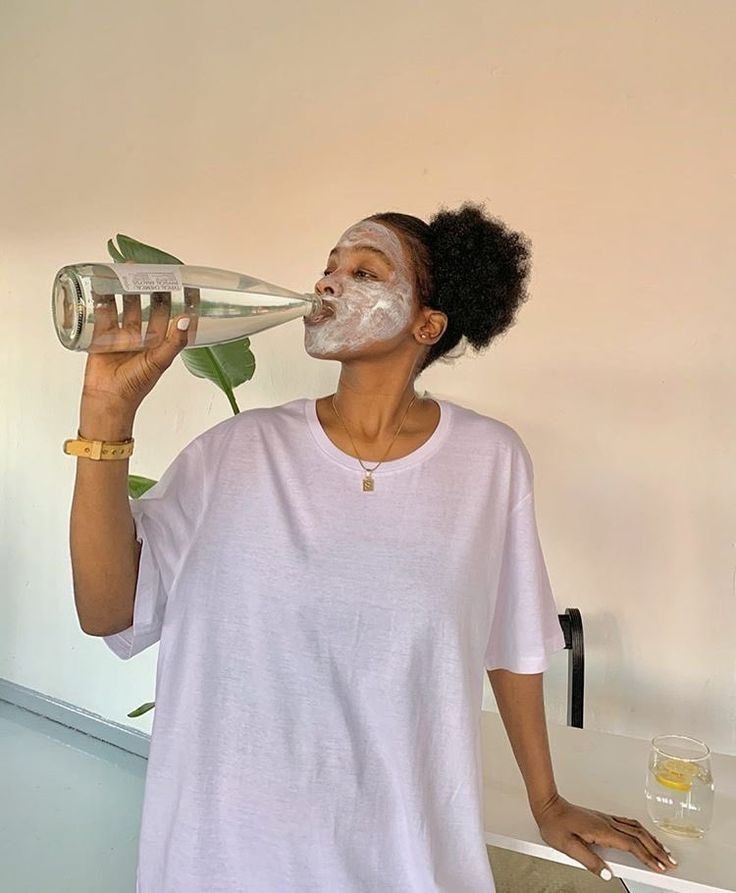 Black woman drinking water summer natural hair lifestyle