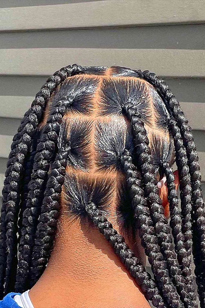 Woman wearing large jumbo box braids with natural hair