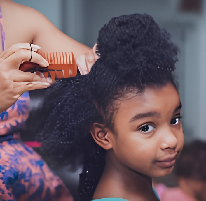 Parent gently preparing a child's 4C hair before wash day