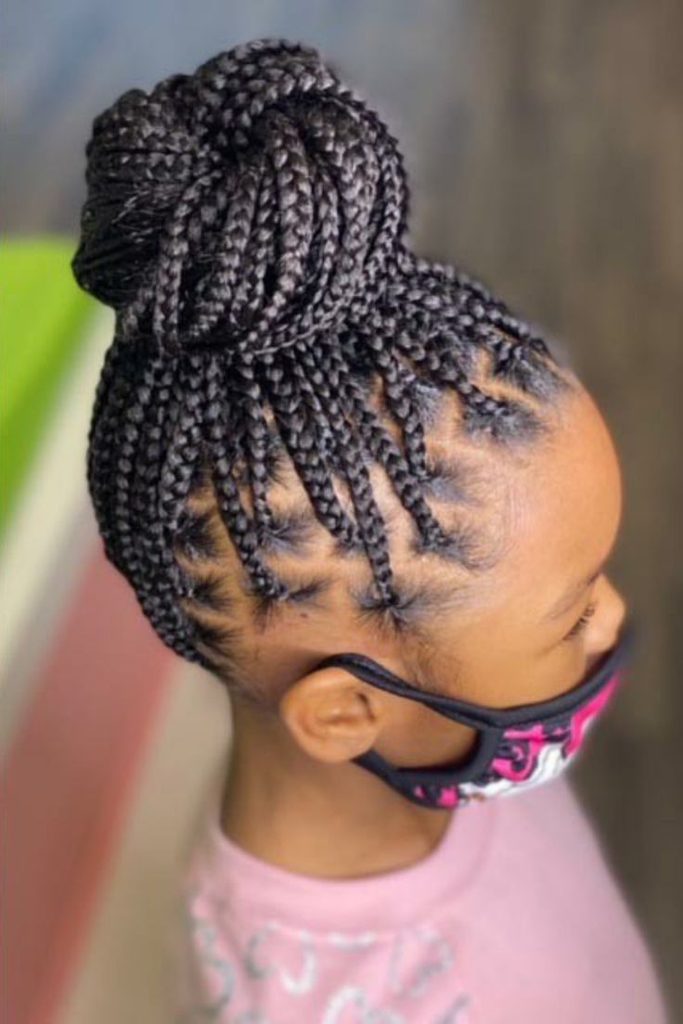 Braided bun on a child with natural 4C hair