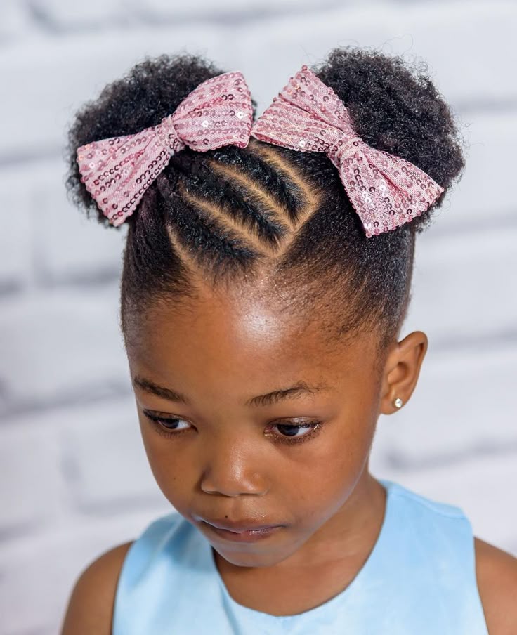 Two flat-twist buns on a child with 4C hair