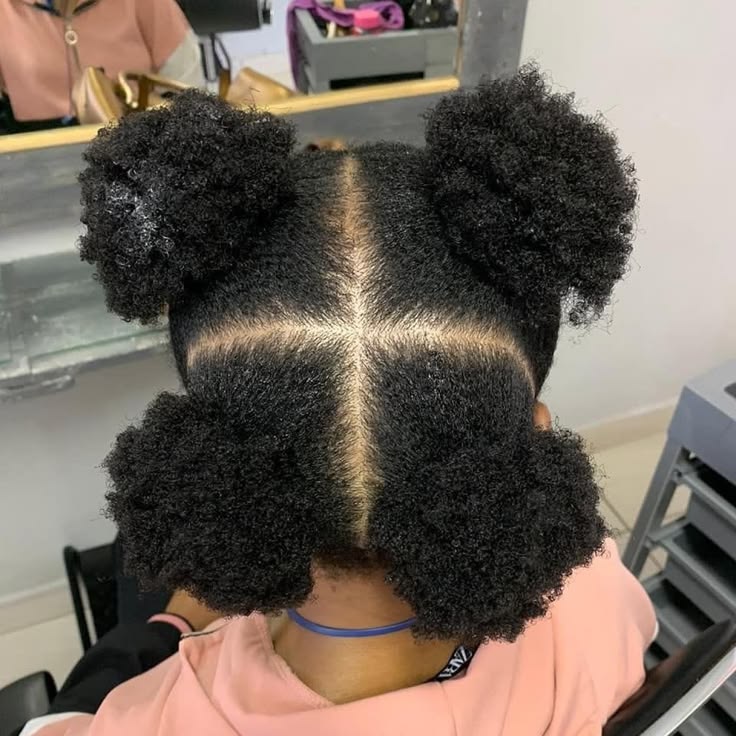 Four mini puffs on a child with natural 4C hair