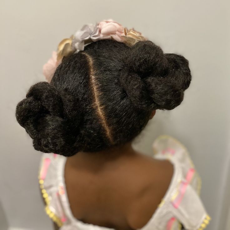Two twist buns with ribbons on natural 4C hair