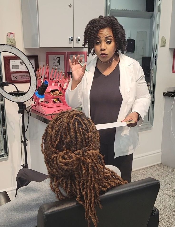 Woman discussing loc installation options with a professional loctician