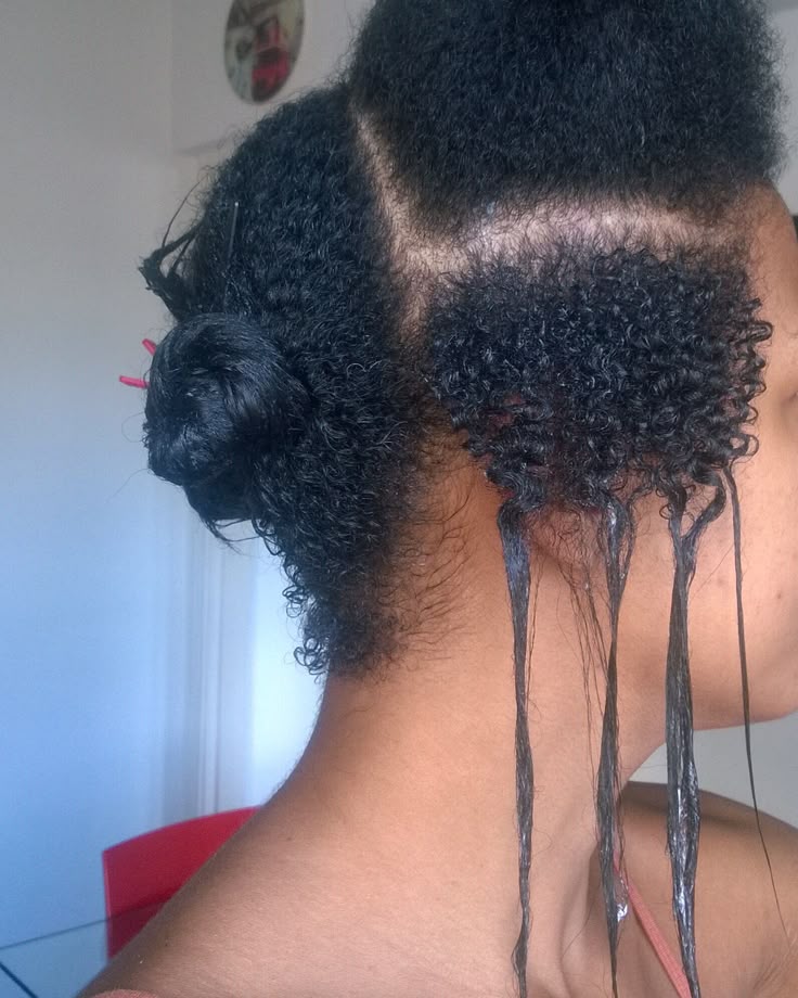 Woman growing out natural hair while keeping relaxed ends