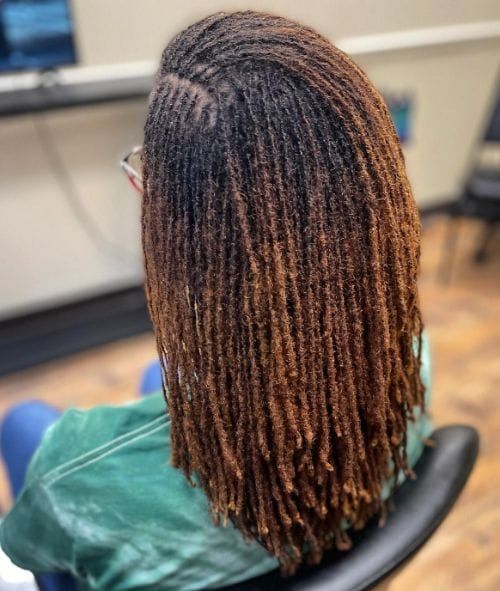 Woman wearing established microlocs as part of a long-term natural hair journey