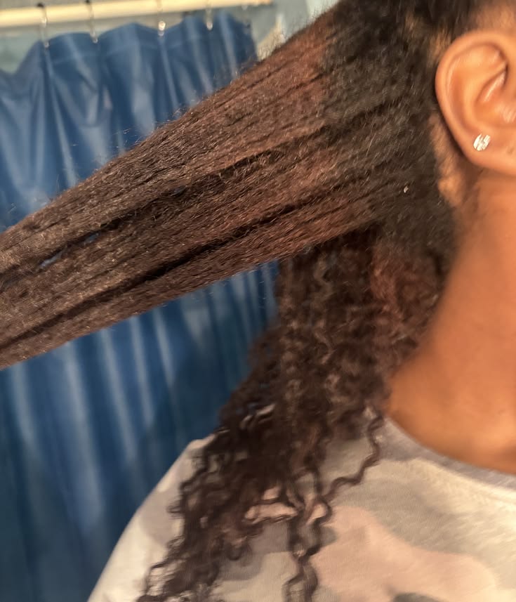 Woman with growing natural roots during a long hair transition