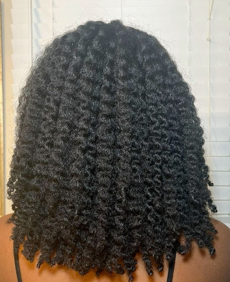 Long natural hair styled in a defined twist-out