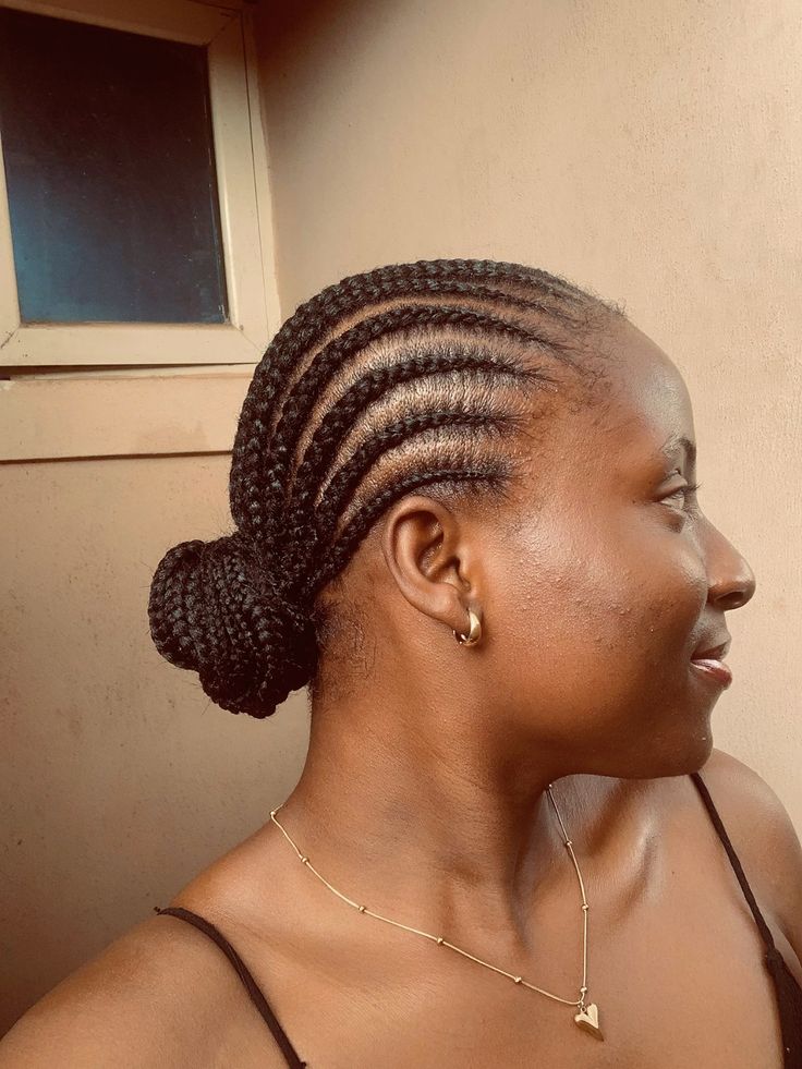 Woman wearing a low cornrow bun on natural hair for rainy day