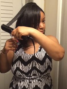 Woman carefully stretching natural 4C hair with low heat