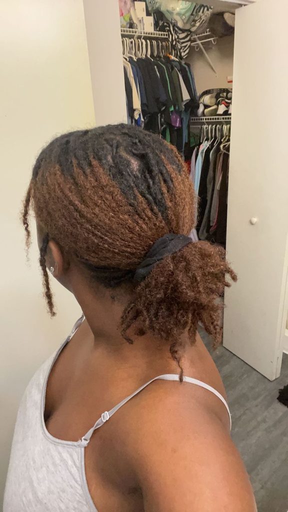 Loose low ponytail created with starter loc