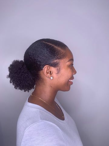 Woman wearing a low puff with styled edges