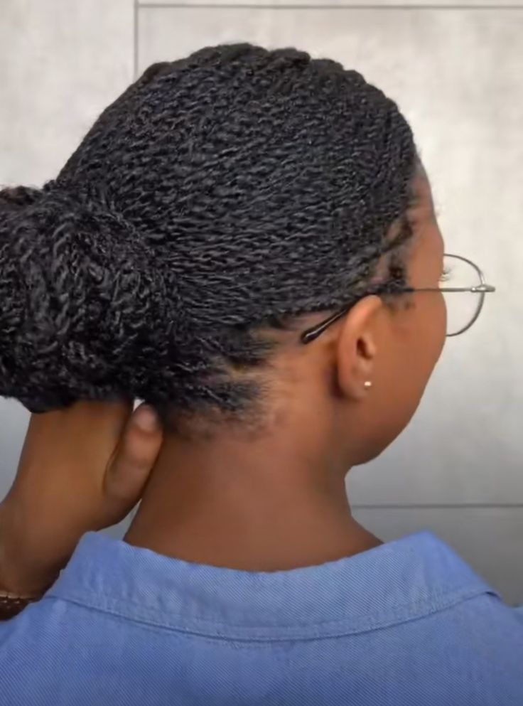 Woman wearing a low two-strand twist bun