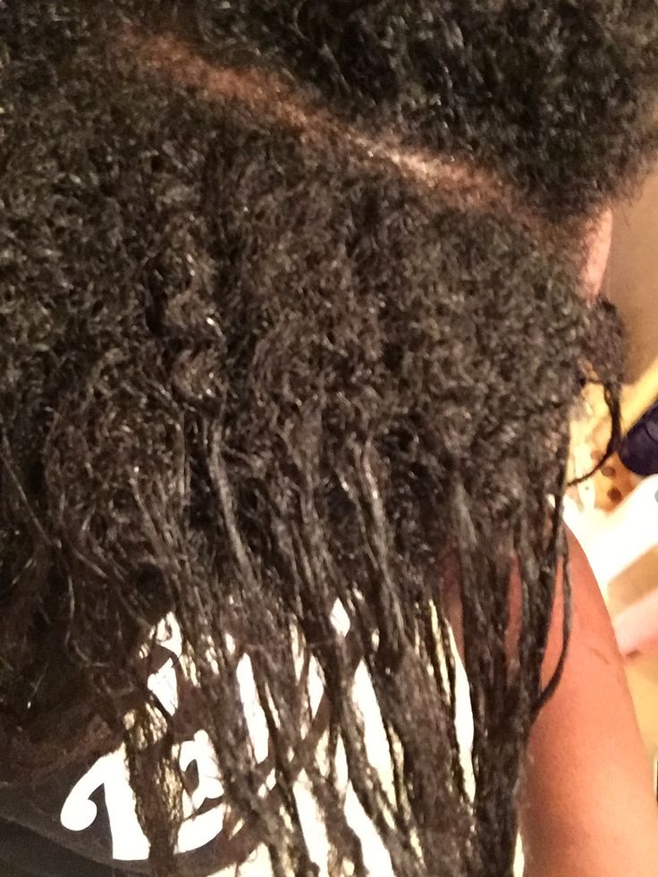 Transitioning hair showing natural roots and relaxed ends in two textures