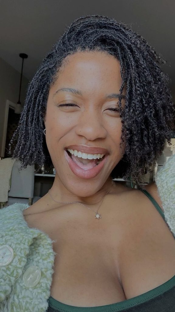 Woman confidently wearing mature microlocs with healthy natural hair