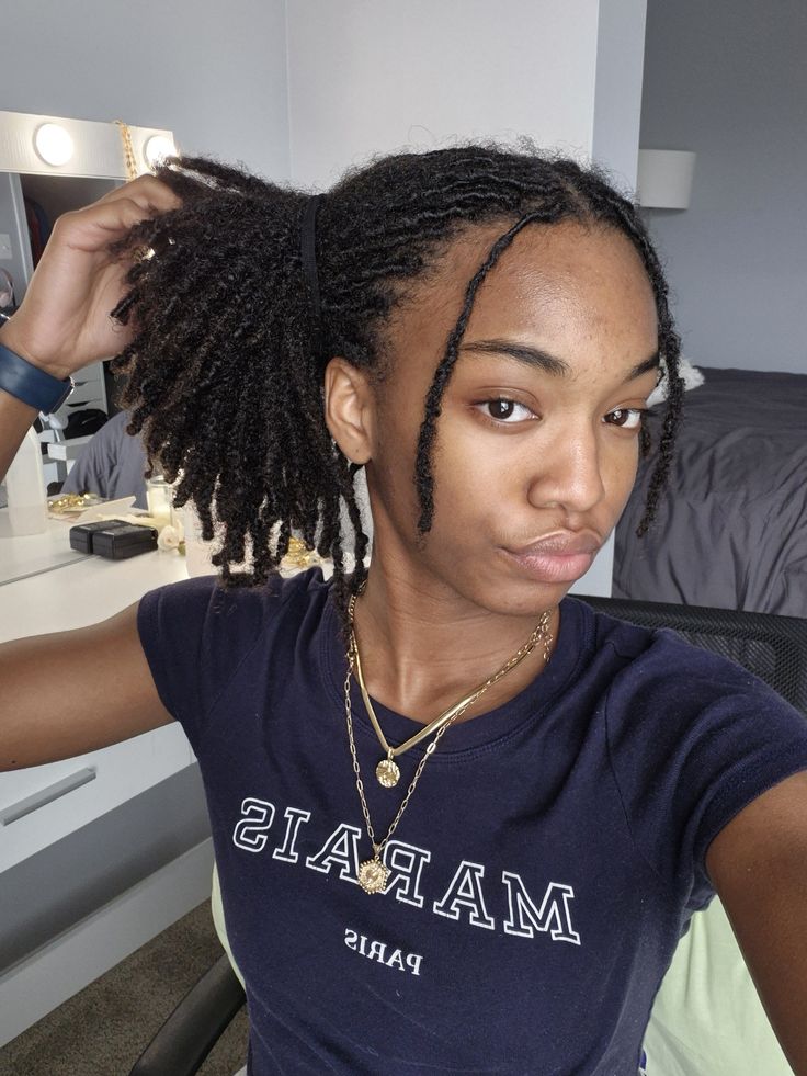 Woman wearing naturally matured starter loc with a simple hairstyle