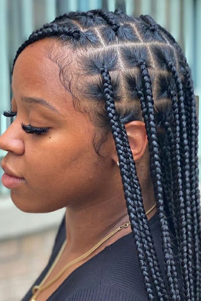 Woman wearing medium-sized box braids on 4C hair