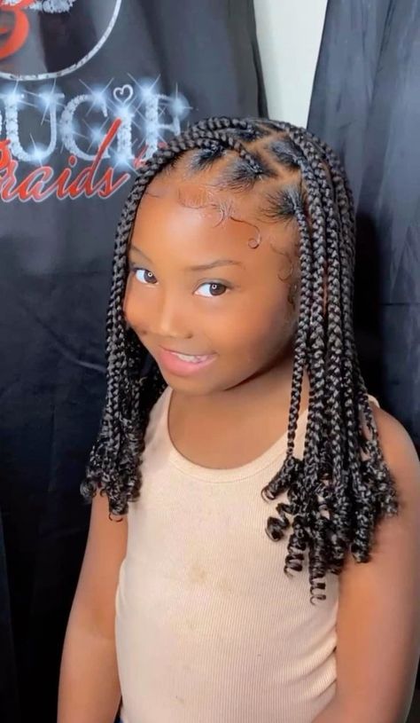 Child with medium-sized box braids wearing a comfortable protective hairstyle