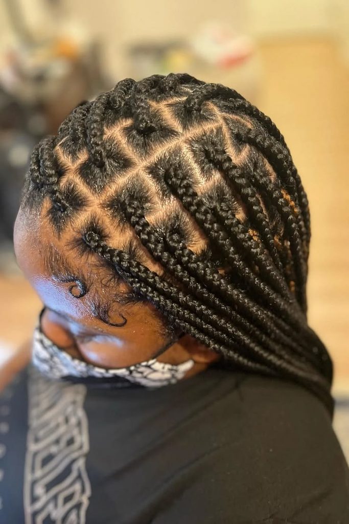 Woman wearing medium box braids as a rainy day hairstyle for rainy day