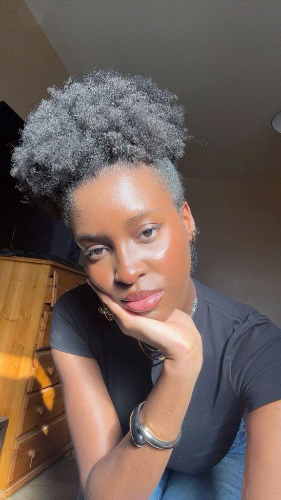 Medium-length natural 4C hair styled into a full puff