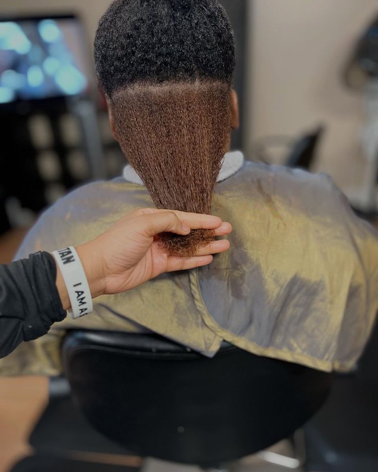 Loctician examining natural hair density before microloc installation