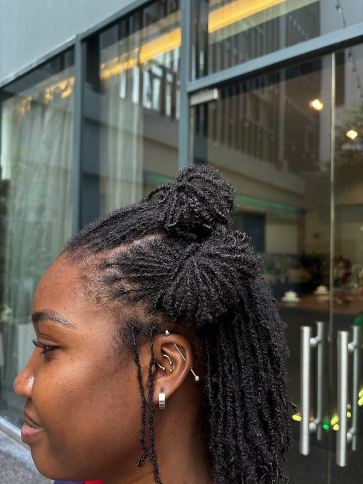 Woman wearing microlocs in a versatile natural hairstyle