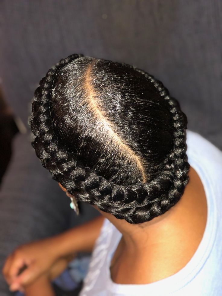 Woman wearing classic milkmaid braids on natural hair
