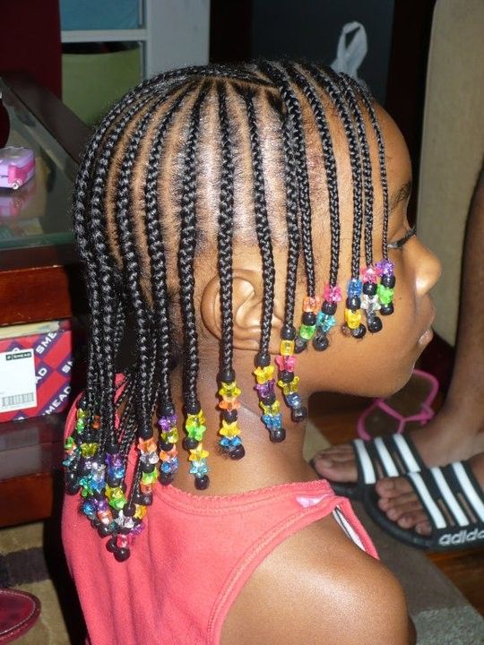 Black child wearing cornrows decorated with colorful beads protective hairstyle
