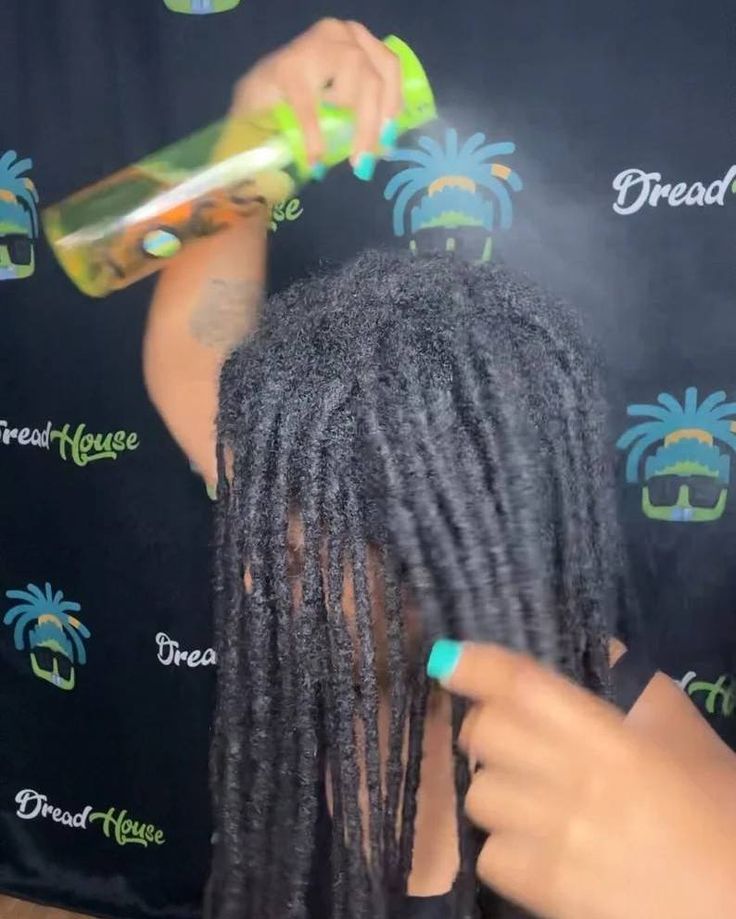 Woman moisturizing her natural microlocs with a lightweight product